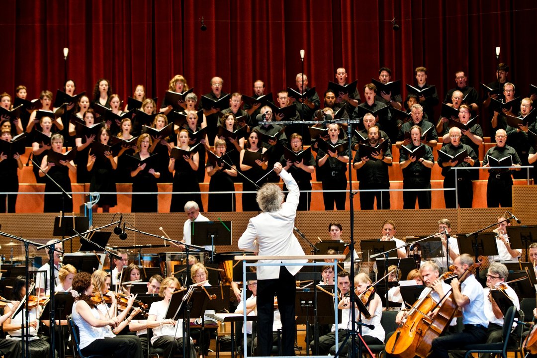 Conductor Carlos Kalmar leading the Grant Park Orchestra and Chorus on Jay Pritzker Pavilion stage