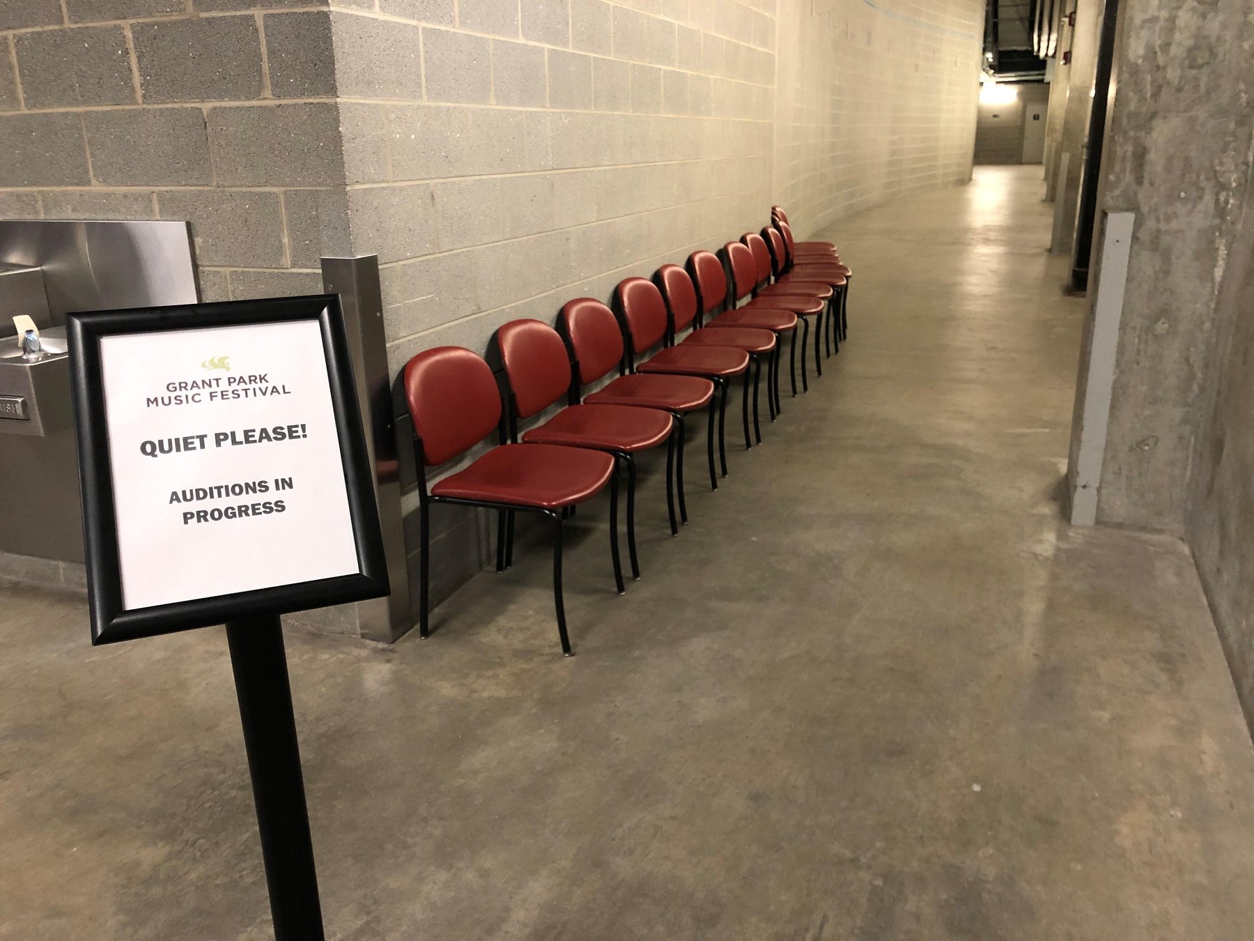 Sign for auditions and row of empty seats