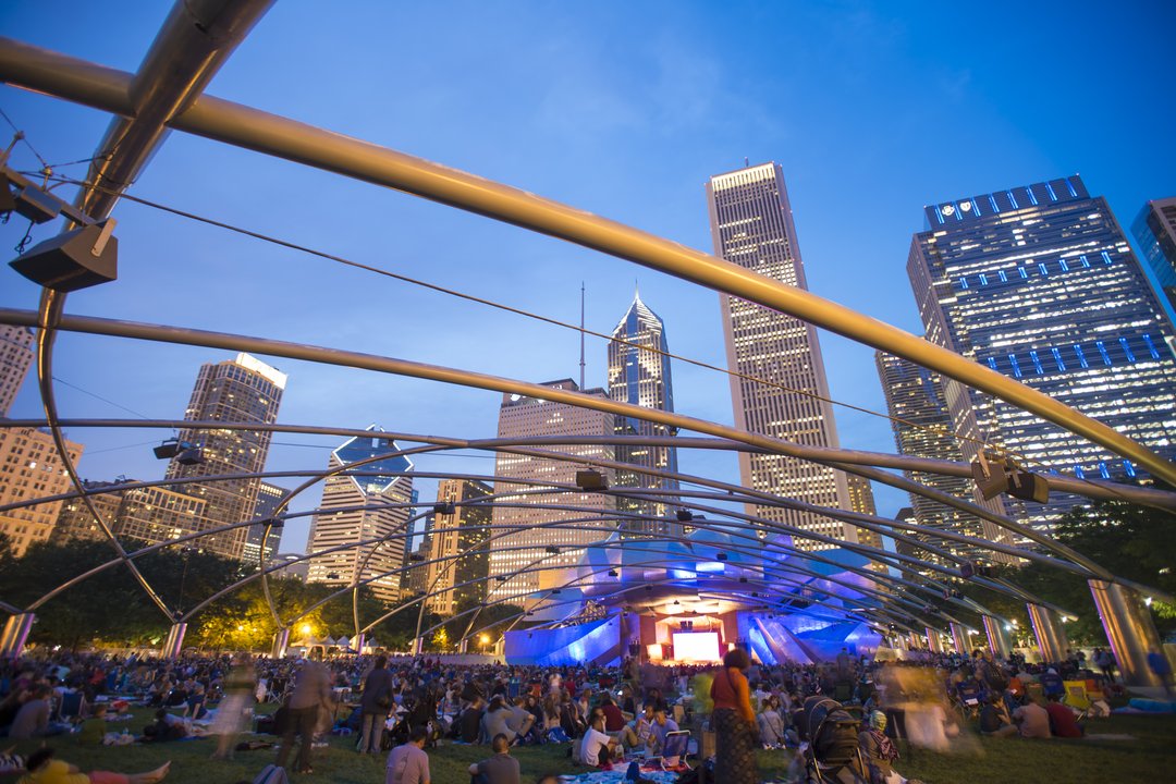 Concertgoers gathering on The Great Lawn enjoying a performance from Jay Pritzker Pavilion Stage