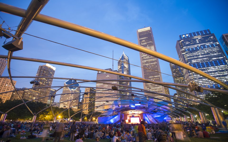 Concertgoers gathering on The Great Lawn enjoying a performance from Jay Pritzker Pavilion Stage