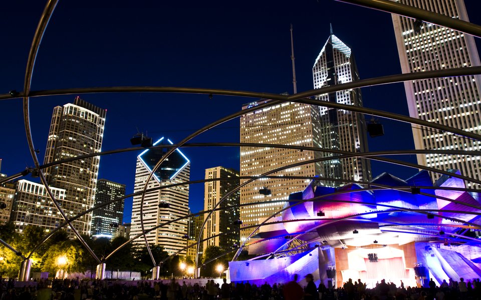 Pritzker Pavilion and backdrop of Chicago skyline at night